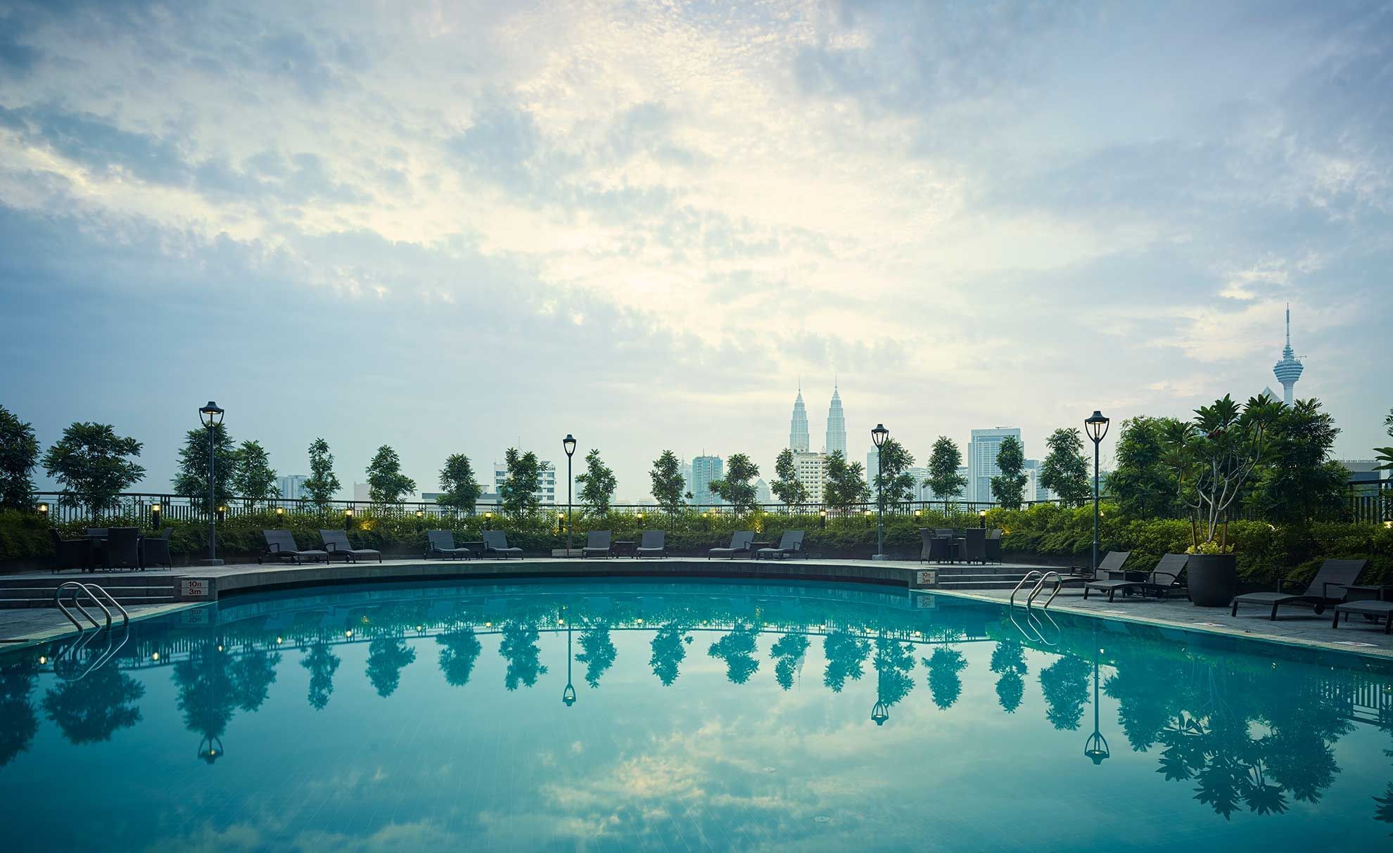 Exterior view of hotel pool with sunbeds at Sunway Putra Hotel